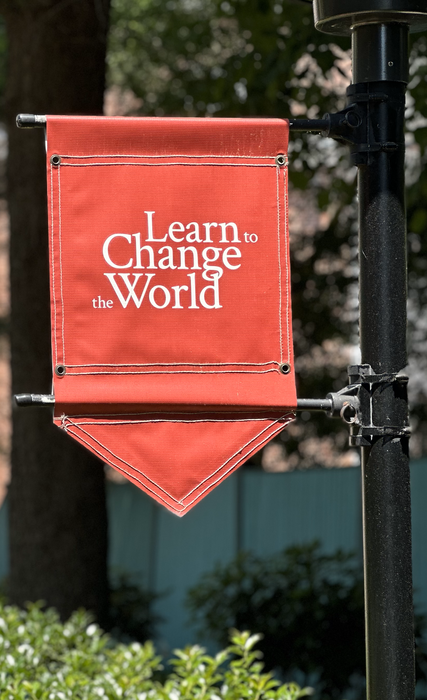 A banner on Harvard's campus that reads "Learn to change the world."
