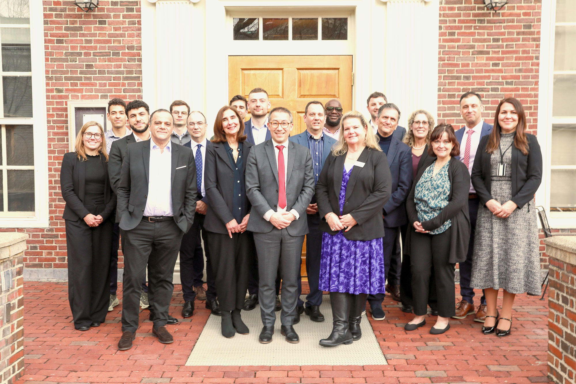 A group of people from the Harvard Division of Continuing Education and Audencia Business School pose for a photo.