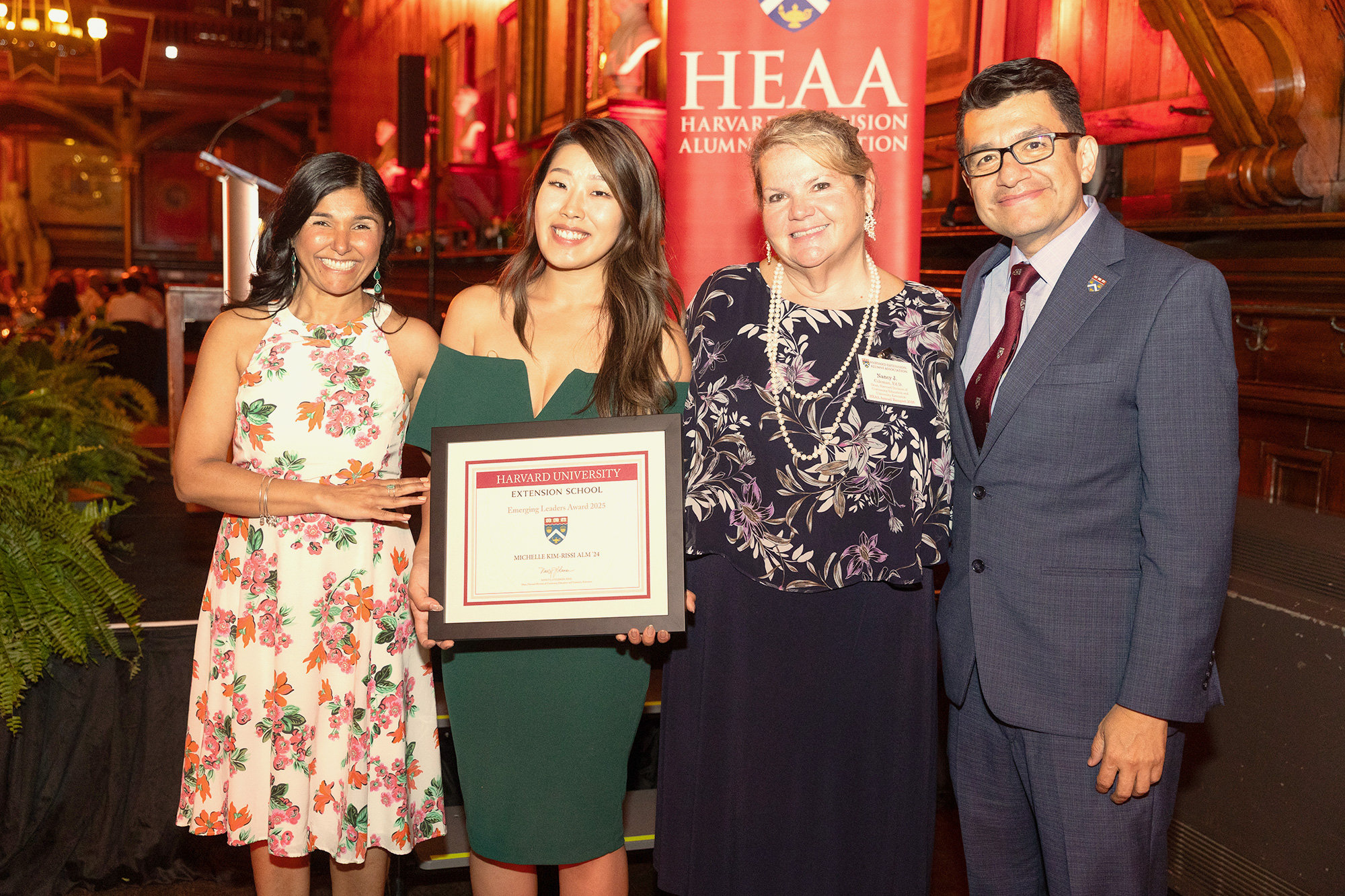 Three Harvard Extension School Alumni Association award winners with Nancy Coleman.