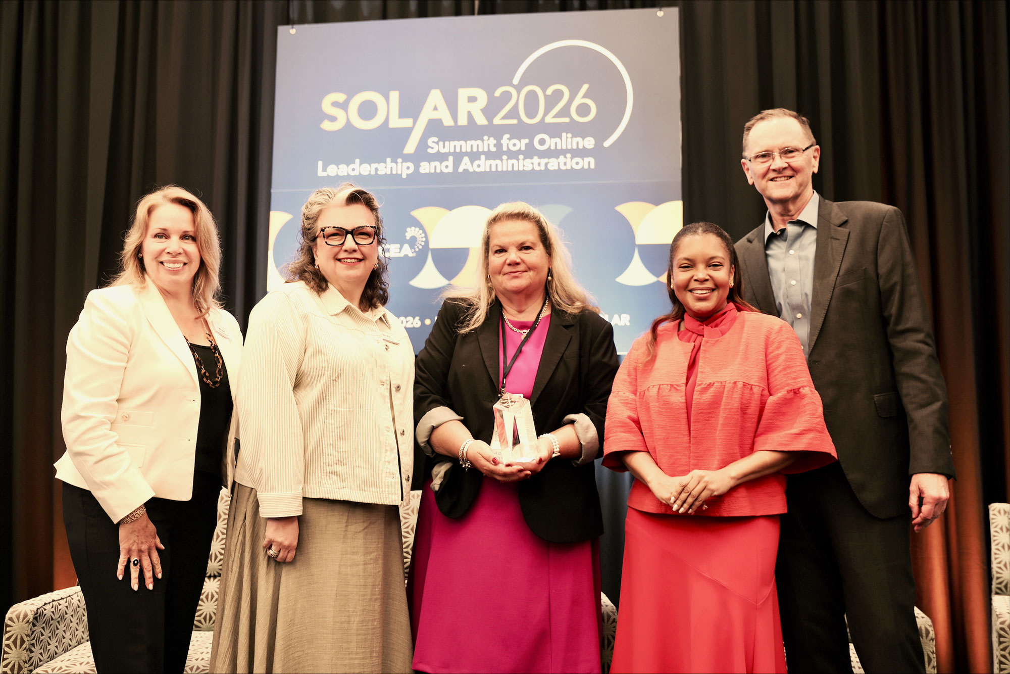 Dean Nancy Coleman poses for a photo after being awarded the Ray Schroeder Leadership Award.